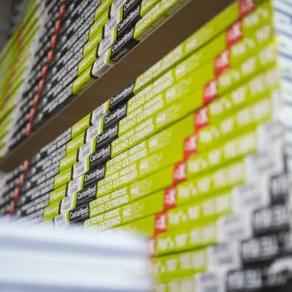 Stacks of drywall products and boxes in warehouse