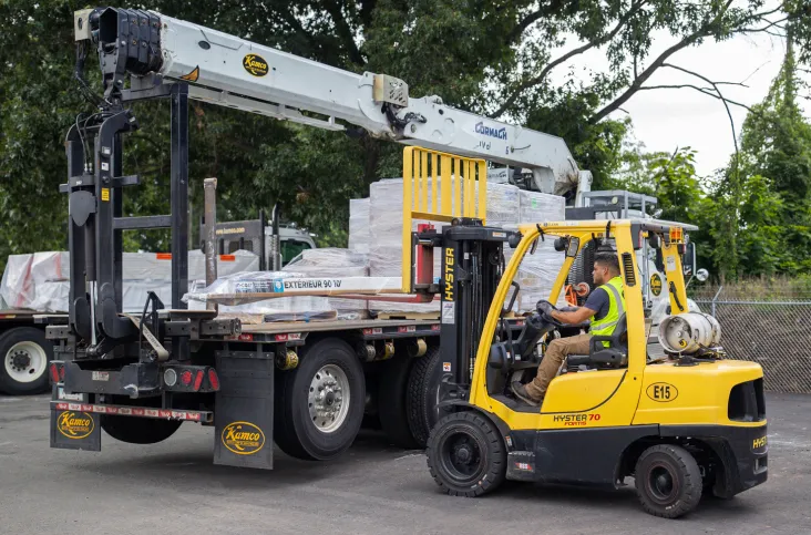 Kamco delivery driver placing products on truck